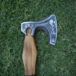 Close-up of the Viking axe’s carbon steel blade with intricate engravings, showcasing Norse symbols and Valhalla text