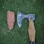 Hand-forged Viking axe with a braided leather grip, featuring a carbon steel blade and a wooden handle and leather cover