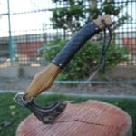 Hand-forged Viking axe with a wooden handle and leather grip