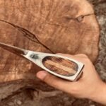 Top-Down View of Viking Pizza Cutter Axe - Ash Wood Handle and Steel Blade Silhouette