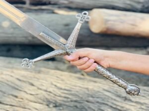 Close-up of man's hand gripping J2 Steel Medieval Claymore Sword