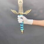 Close-up of man's hand gripping Legend of Zelda Master Sword replica handle
