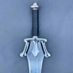 Close-up of stainless steel He-Man Power Sword handle, featuring ergonomic design for secure grip during cosplay or display