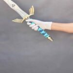 Man holding Legend of Zelda Master Sword replica to showcase size and weight